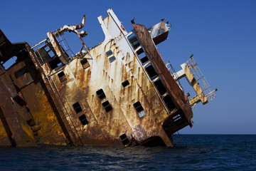 a ship sunk in the sea, carrying smuggling and flying on the stones. rusty frame.