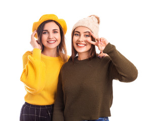 Young women in warm sweaters on white background