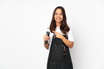 Young hairdresser woman isolated on white background pointing to the side to present a product