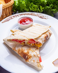 pita meat roll with chicken meat tomato cheese and corn