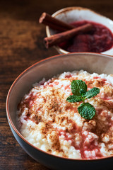Rice pudding with plum roaster and cinnamon