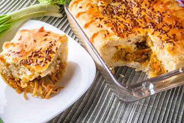 freshly baked cabbage pie on rustic wooden background