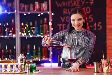 Beautiful female bartender in pub