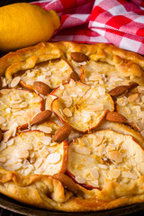 crispy apple galette with almonds on rustic wooden background