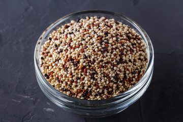 mix of quinoa grains on a dark stone background