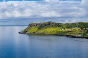 Obraz premium Hebrides islands cape and scottish village under the hills. Island of Skye, Scotland.