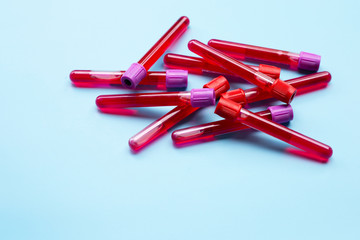 Blood in test tubes on blue background.