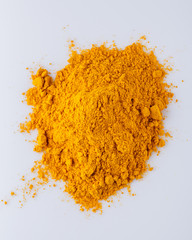 natural turmeric powder on white acrylic background