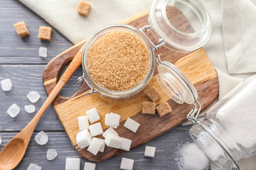 Different sugar on wooden background