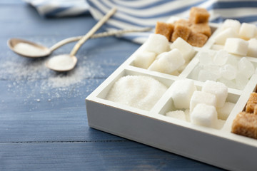 Different sugar on wooden background