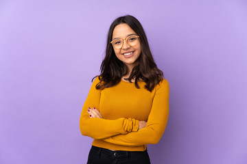 Young mixed race woman isolated on purple background keeping the arms crossed in frontal position
