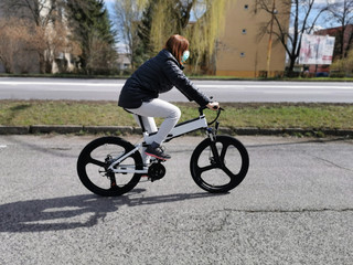 Woman riding a bike with respirator mask