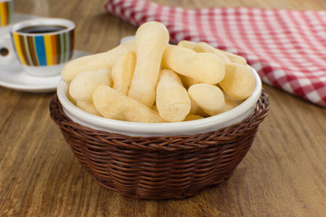 Traditional Brazilian starch biscuit called biscoito de polvilho in a basket in a wood background coffe table