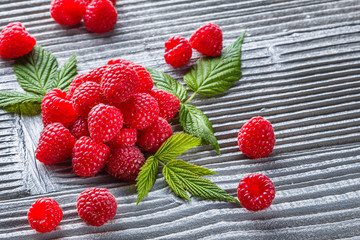 juicy fresh natural raspberries on a gray wooden rustic background
