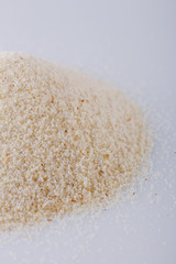 natural organic semolina on white acrylic background