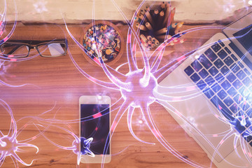 Double exposure of neuron drawing over table with phone. Top view. Science education concept.