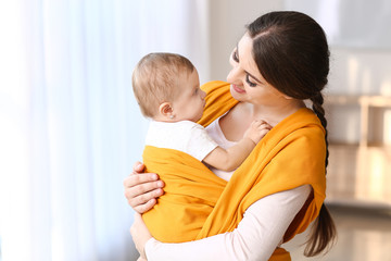 Happy mother with cute little baby at home