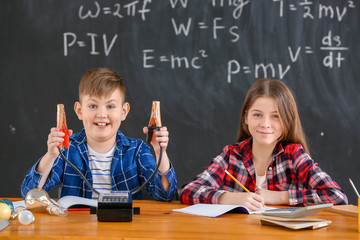 Cute little children at physics lesson in classroom