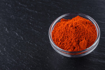 aromatic ground paprika on a dark stone background