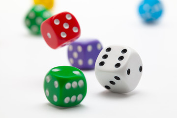 Playing dice at white wooden background.