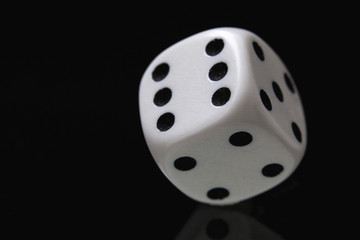 White dice on the black background.