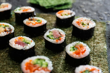 Tasty sushi rolls on table