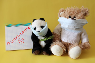 Soft toys bear and panda in medical masks on a yellow background. Schools and kindergartens are under quarantine. Home schooling. Quarantine sign.