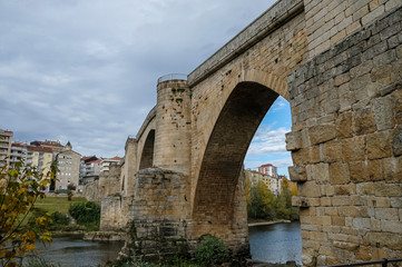 Fototapeta na wymiar Bridge of Roman foundation over the river Miño in Ourense. Galicia, Spain.