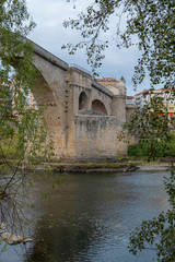 Obraz premium Medieval bridge of Roman foundation over the river Miño in Ourense