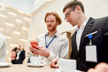 Entertain. Colleagues having coffee, tea during break at business meeting, forum