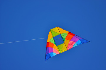 A colorful kite flying in the blue sky