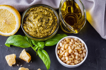 Delicious traditional italian pesto sauce on dark stone background