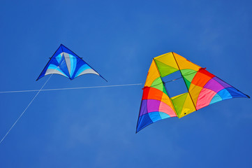 Two colorful kites flying in the blue sky