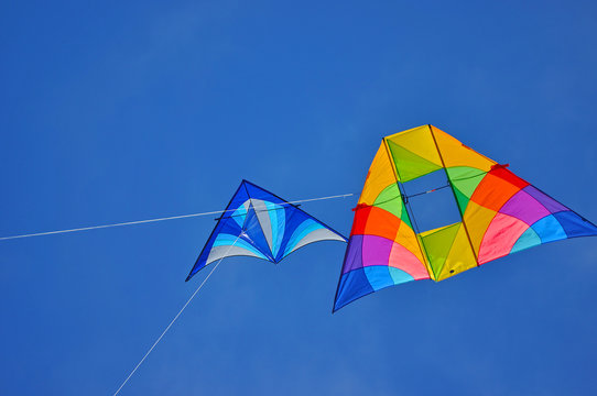 Two colorful kites flying in the blue sky
