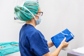 Covid-19. Female nurse puts on protective cloths. Personal protective equipment in the fight against Coronavirus disease .