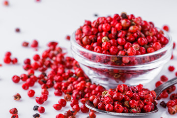 fragrant pink peppercorns on white acrylic background