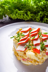 salad of fish sticks on dark wooden rustic background
