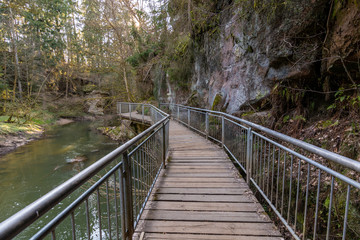 Fototapeta premium Wooden planks as a path with metal railings in the ravine Schwarzachklamm