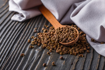 Sichuan pepper on a dark wooden rustic background
