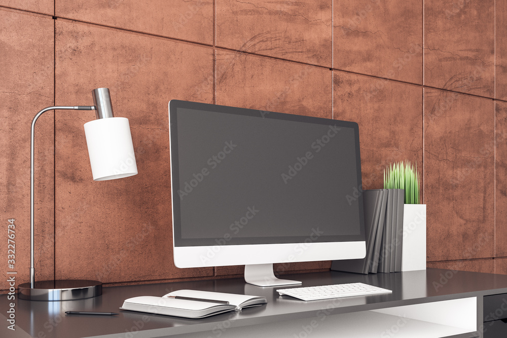 Poster Designer workplace with blank computer screen and red wall.