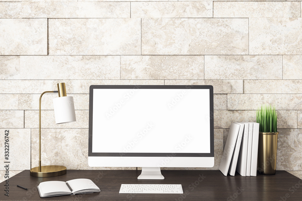Poster computer on modern designer workplace with white screen.