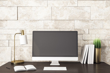 Computer on modern designer workplace with blank screen.