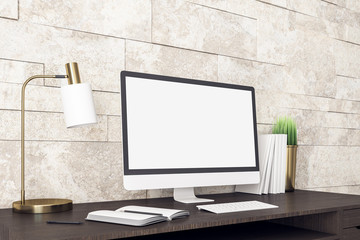 Computer on contemporary designer workplace with white screen.