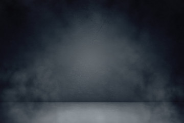 Front view of interior room with blank concrete wall and dark floor.