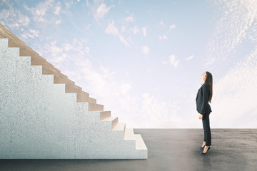 Businesswoman looking on abstract stairs