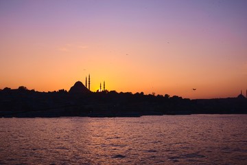 Naklejka premium Hagia Sophia, the most important tourist attraction of Istanbul, Turkey, silhouetted against the twilight sky from across the Bosphorus.