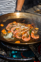 chef cooks shrimp at street food festival