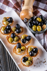 delicious snack tartlets on rustic wooden background