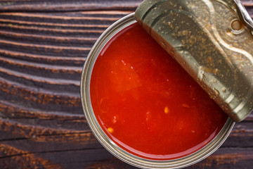 juicy canned tomatoes on wooden rustic background