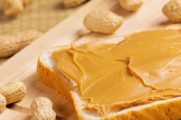 Obraz na płótnie Canvas Delicious peanut butter sandwich on a wooden background